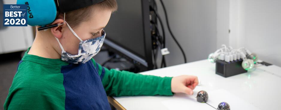 Student working at a desk wearing a mask